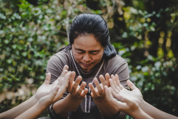 istock Group of different women praying together 1208278430
