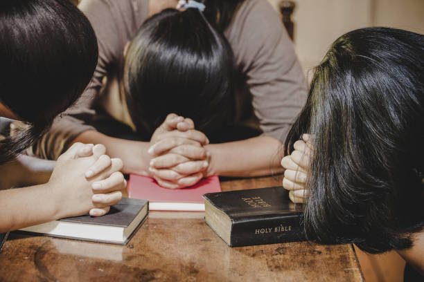 istock Group of different women praying together 1208278436