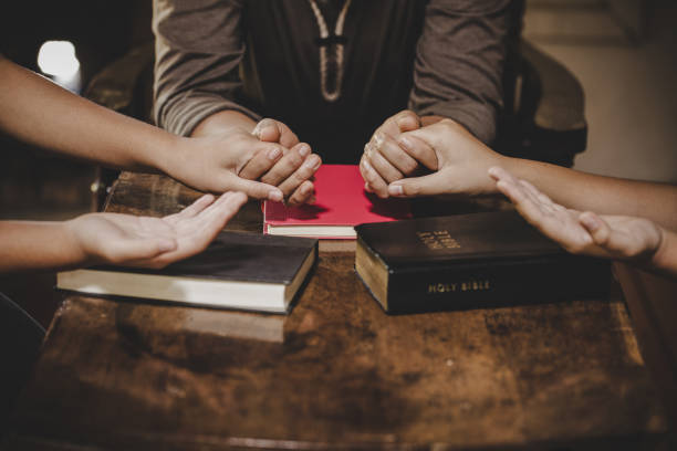 istock Group of different women praying together 1208278441