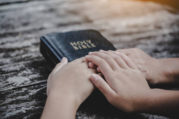 istock Group of different women praying together 1208278449