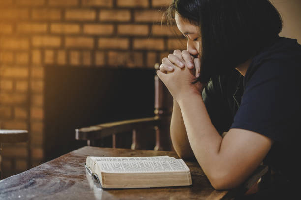 istock Girl while praying for christian religion 1208278481