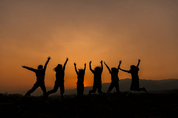 istock Group of happy people playing at summer sunset 1208278484