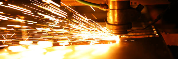 istock Bright blaze and sparkles while automated laser device cutting steel 1208281458