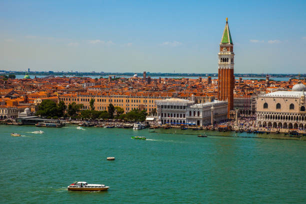 Looking out towards St. Mark's Square View of St Mark's Square and the Bell Tower from the Grand Canal in Venice venice italy grand canal honeymoon gondola stock pictures, royalty-free photos & images