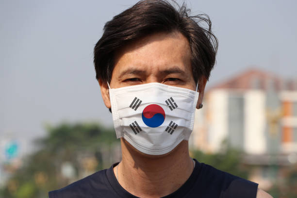 South Korea flag on hygienic mask. Masked Asian man prevent germs. concept of Tiny Particle protection. South Korea flag on hygienic mask. Masked Asian man prevent germs. concept of Tiny Particle protection or virus corona. harm stock pictures, royalty-free photos & images