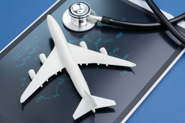Airplane on chemical compound with headline COVID-19 on chalkboard with stethoscope using as travel and tourist impact with Virus outbreak in China and spreading world wide stock photo