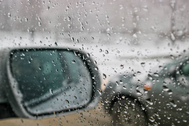 istock View from the car windscreen during rain and wet snow. Poor visibility while driving around the city. Snowy road. 1208291768