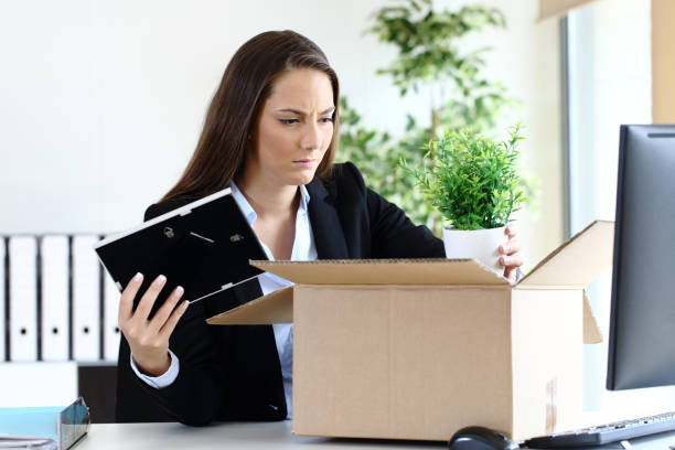 istock Sad fired employee boxing belongings at office 1208292812