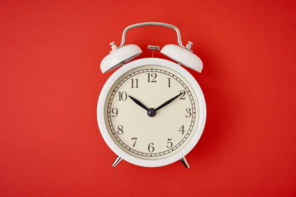 istock White retro alarm clock on the red background with copy space. Time concept 1208294095