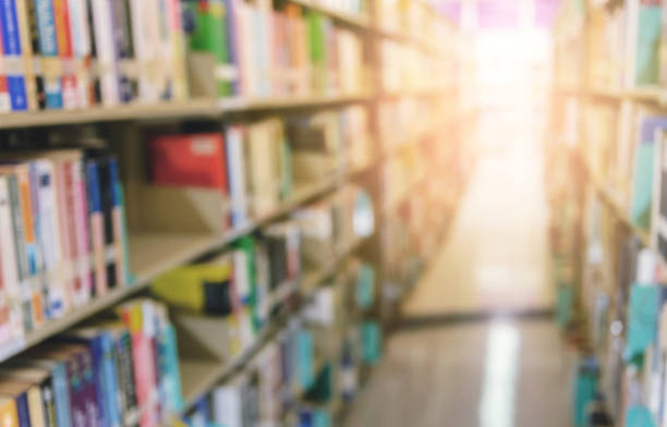 istock Abstract blurred image of books on bookshelf in school library. education learning or back to school concept background 1208296171