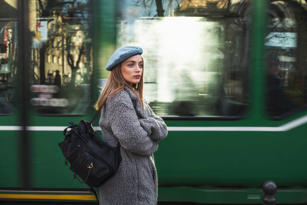 Woman Portrait Waist up portrait of beautiful fashion woman, she standing in front of green blurred motion tram transport in the city. blurred motion street car green stock pictures, royalty-free photos & images