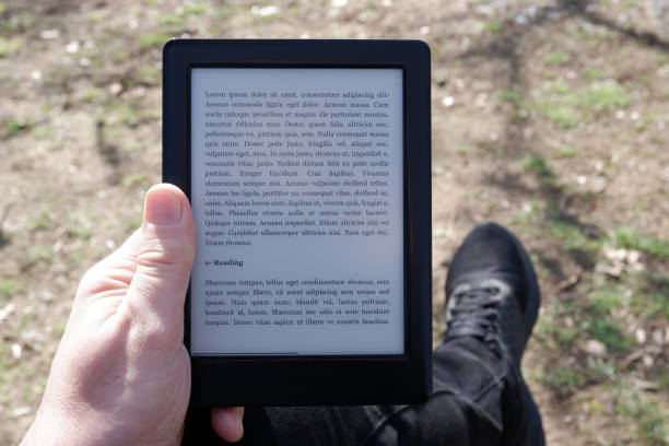 istock Hand of a man reading the e-book in the e-book reader 1208303580