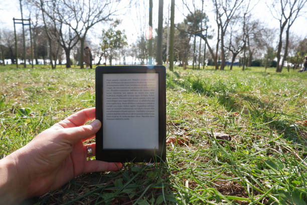 istock Hand of a man reading the e-book in the e-book reader, 1208305213