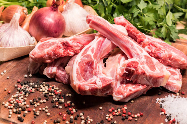 istock raw lamb chops on a wooden board for barbecue 1208306808