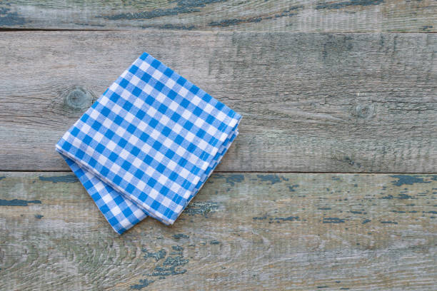 istock Checkered blue-and-white napkin on a wooden table 1208308254