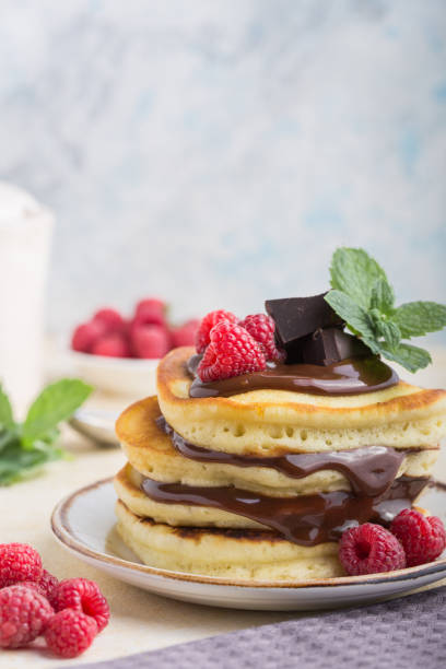 istock Pancakes with raspberry and chocolate.  Stack of tasty buttermilk pancakes. Vertical  composition, breakfast food 1208308482