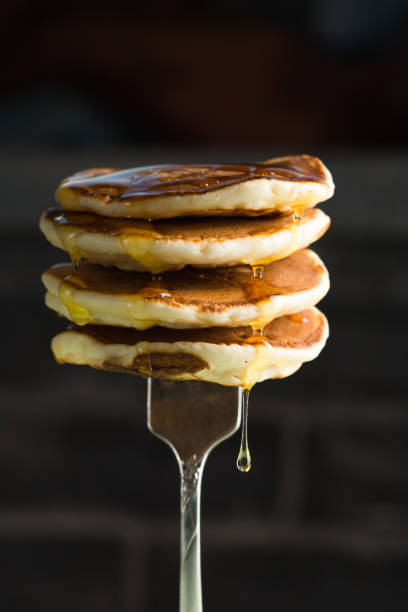 istock Stack of pancakes on fork with honey. Stack of pancakes lavitation 1208308599