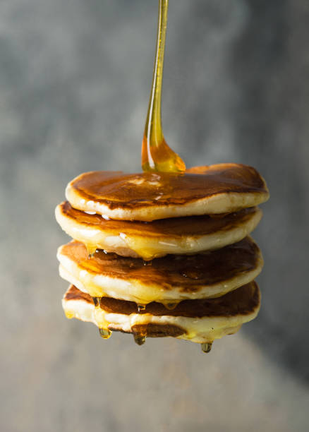 istock Stack of pancakes on fork with honey. Stack of pancakes lavitation 1208308605
