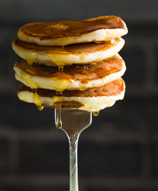 istock Stack of pancakes on fork with honey. Stack of pancakes lavitation 1208308606
