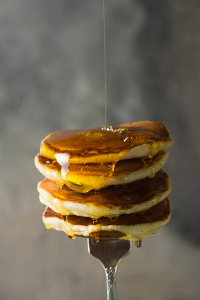 istock Stack of pancakes on fork with honey. Stack of pancakes lavitation 1208308614
