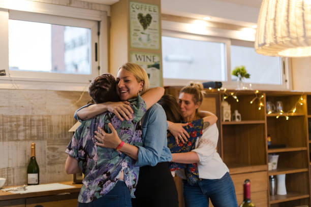 istock Couples hugging arriving at friends for a barbecue dinner 1208309292