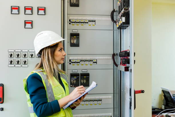 istock Young female maintenance engineer working at energy control room 1208309320