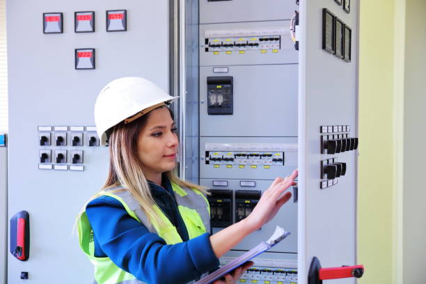istock Young female maintenance engineer working at energy control room 1208309339