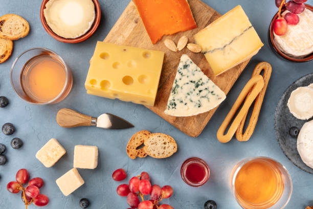 istock Cheese platter. Blue cheese, Brie, Emmental, goat cheese with wine and fruit, overhead flat lay 1208309441