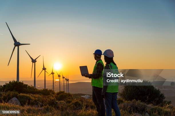 Windmills And Workers Stock Photo - Download Image Now - In Silhouette, Engineer, Working
