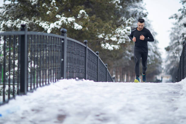 istock Young athletic man exercising in the winter 1208310788