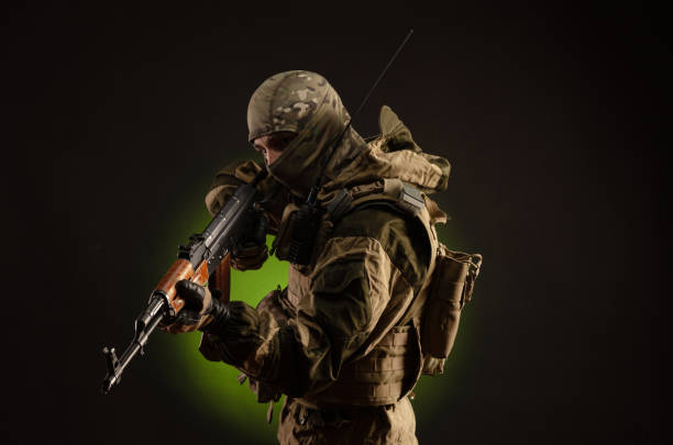 soldier militia saboteur in military clothing with a Kalashnikov rifle on a dark background the soldier militia saboteur in military clothing with a Kalashnikov rifle on a dark background donets basin photos stock pictures, royalty-free photos & images