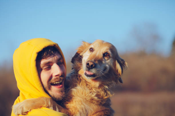 istock Man And Dog Enjoying Sunny Day In Nature 1208311044