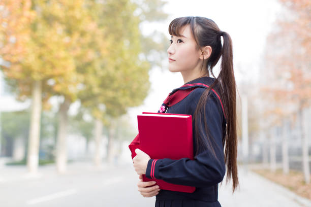 istock cute chinese female students 1208311234