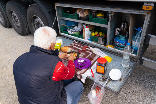 Kirikkale/Turkey-October 27 2019: Truck driver takes a break in his portable kitchen with cupboards of food while resting