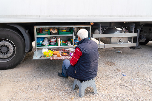 Kirikkale/Turkey-October 27 2019: Truck driver takes a break in his portable kitchen with cupboards of food while resting