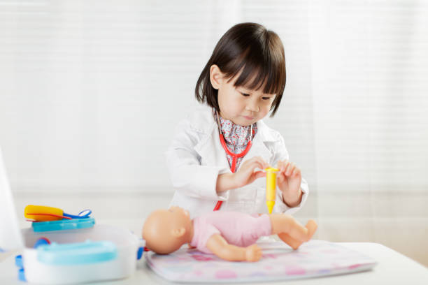istock Cute Doctor Playing With Toys On Table 1208314505