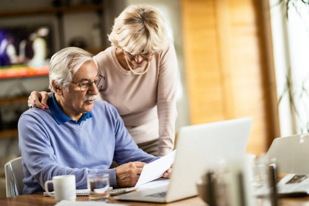 istock Mature couple going through financial bills at home. 1208315121