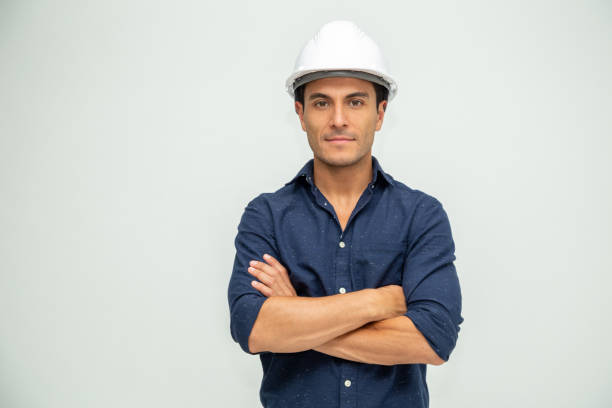 guapo hombre ingeniero industrial con un casco blanco consollado sobre fondo blanco - industrial object fotografías e imágenes de stock