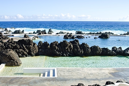 Natural pools with black vlcanic rock in the Atlantic Ocean (Porto Moniz, Madeira, Portugal, Europe)