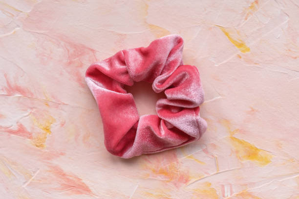 istock One pink trendy velvet scrunchie on pastel background 1208320018