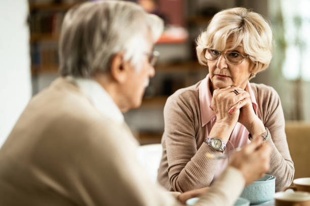 istock Mature woman talking to her husband during breakfast at home. 1208320021