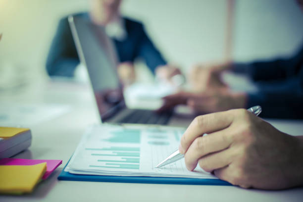 istock Business group or business partners discussing documents and ideas at meeting 1208320028