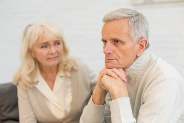 istock Upset elderly couple sitting together in their home 1208320528