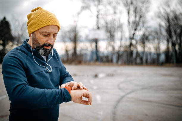istock Mature men running and using smart watch outdoors 1208320655