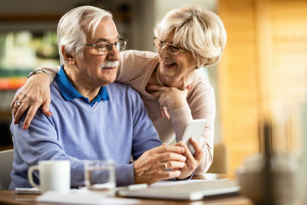 istock Happy senior couple using smart phone at home. 1208322417