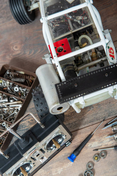 istock Radio-controlled car model with scattered tools for repairing rc buggy models and a control panel. 1208322760