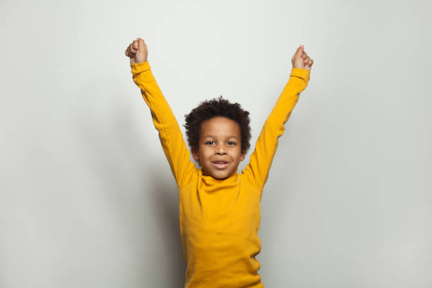 istock Little black kid boy having fun on white background 1208323555