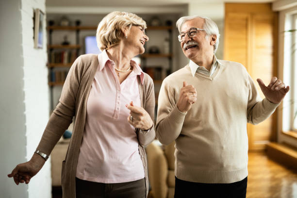 istock Carefree mature couple having fun while dancing at home. 1208323717