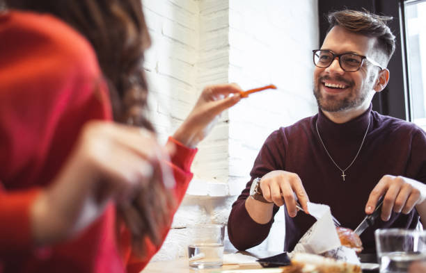 istock Two young people in Fast Food Restaurant 1208324073