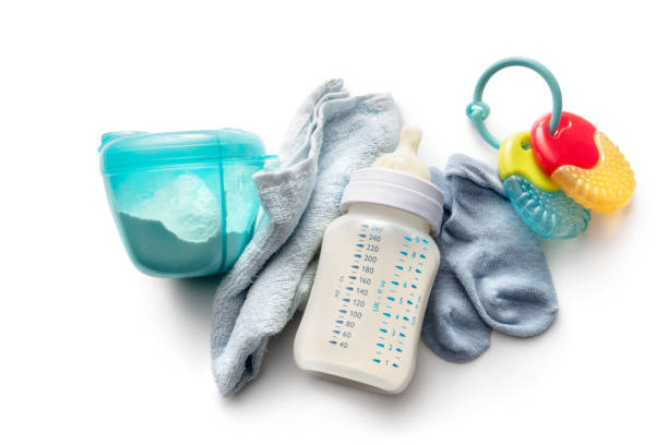 istock Baby Goods: Baby Bottle, Formula, Napkin, Socks and Teething Ring Isolated on White Background 1208325468
